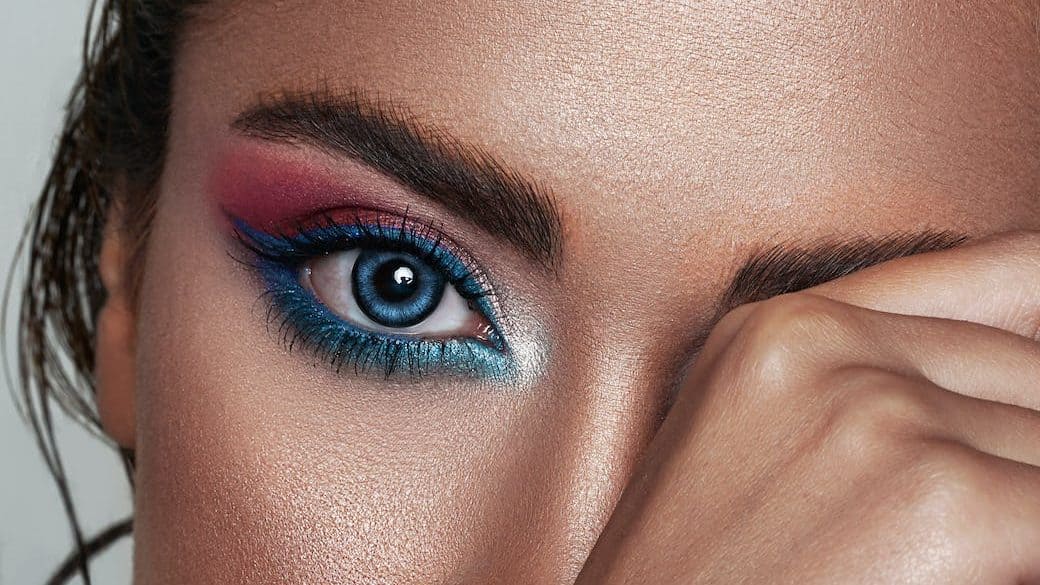 close up photo of a woman wearing bleu eyeliner makeup
