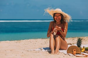 a woman in the beach using a sun screen product