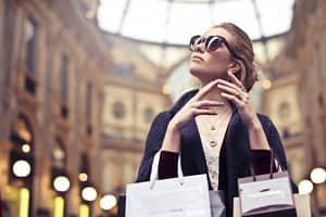 photo of woman wearing sunglasses black friday shopping